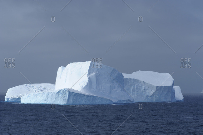Sunlit iceberg in the dark blue waters of the Antarctic Sound at the Antarctic Peninsula, Antarctica
