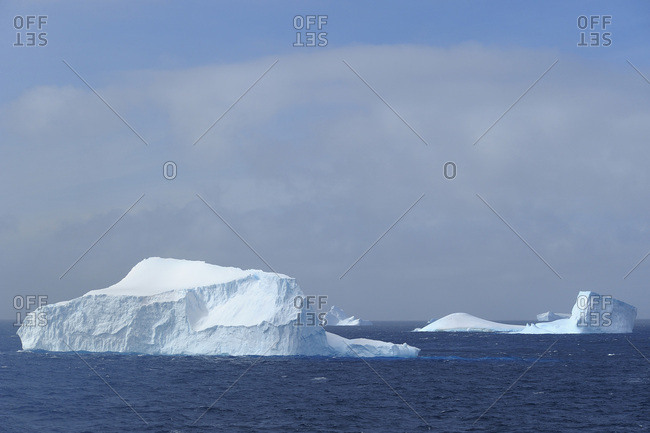Sunlit icebergs floating in the Antarctic Sound at the Antarctic Peninsula, Antarctica