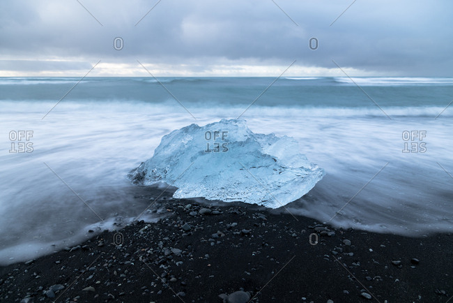 Portion of iceberg washed ashore on beach