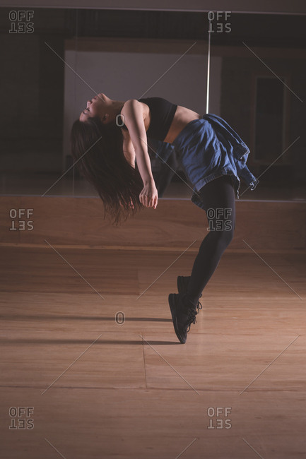 Young female dancer dancing in dance studio
