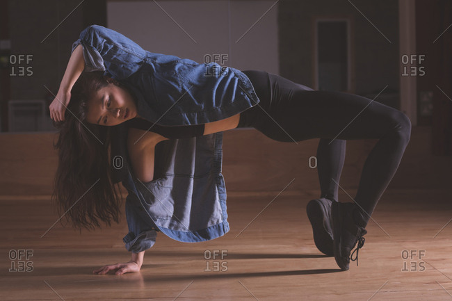 Young female dancer dancing in dance studio