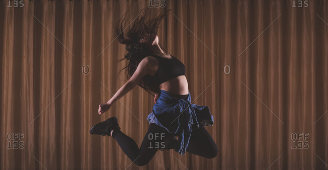 Young female dancer dancing in dance studio