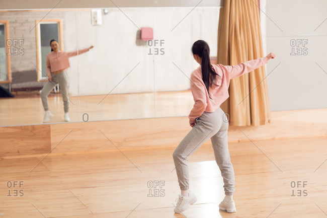 Young female dancer dancing in dance studio