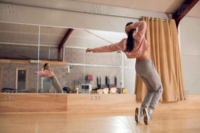 Young female dancer dancing in dance studio