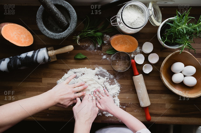 Mother and daughter kneading ravioli dough