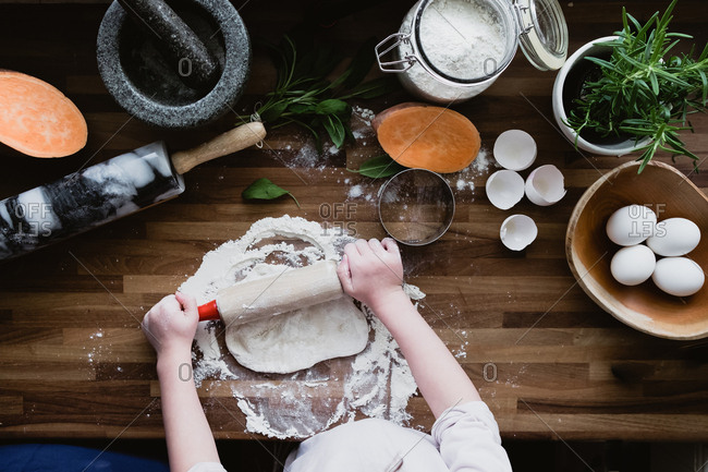 Girl rolls out ravioli dough