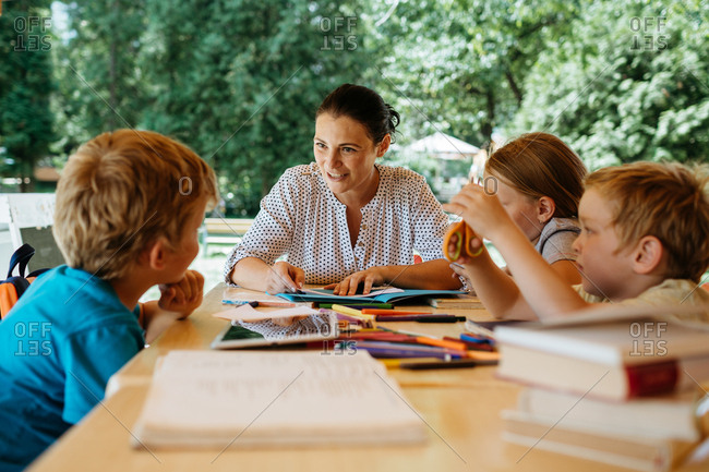 Kids during a reading lesson outside in a park