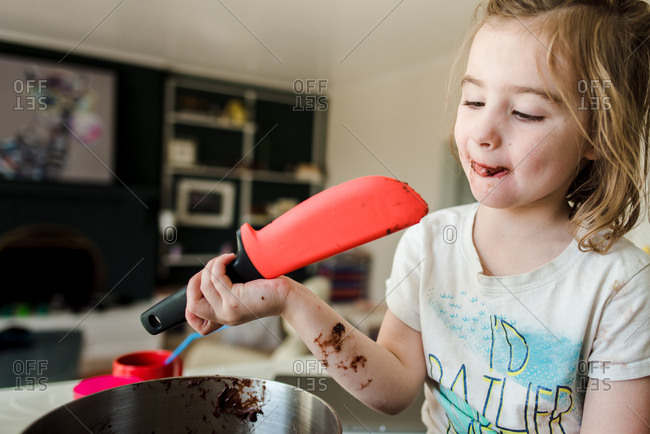 Little girl test tasting baked goods