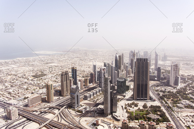 Dubai, United Arab Emirates - May 17, 2012: An aerial view of cluster of skyscrapers and landscape disappearing into desert haze