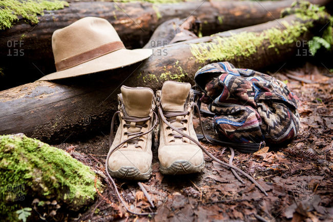 Hiking boots and trilby on mossy forest floor