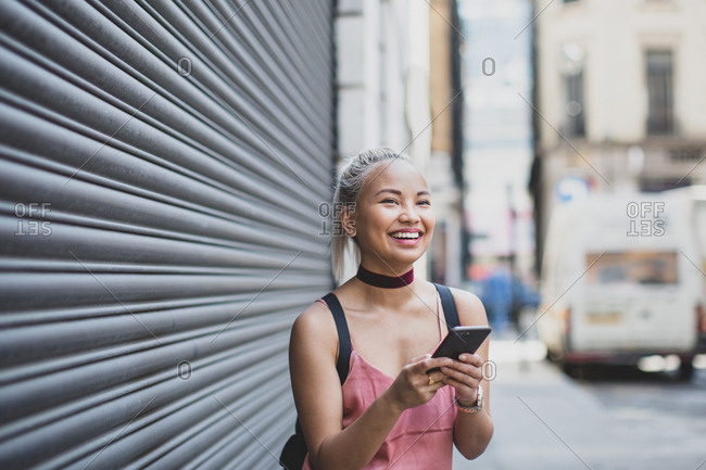 Young adult female messaging on smartphone