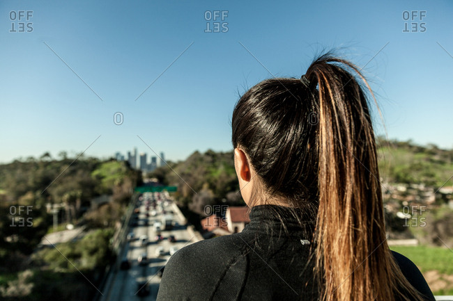 Rear view of woman overlooking highway