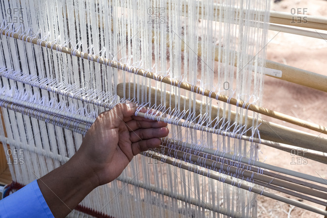 Ganado, Arizona - April 26, 2018: Hand view of native person using loom at Hubbel Trading Post