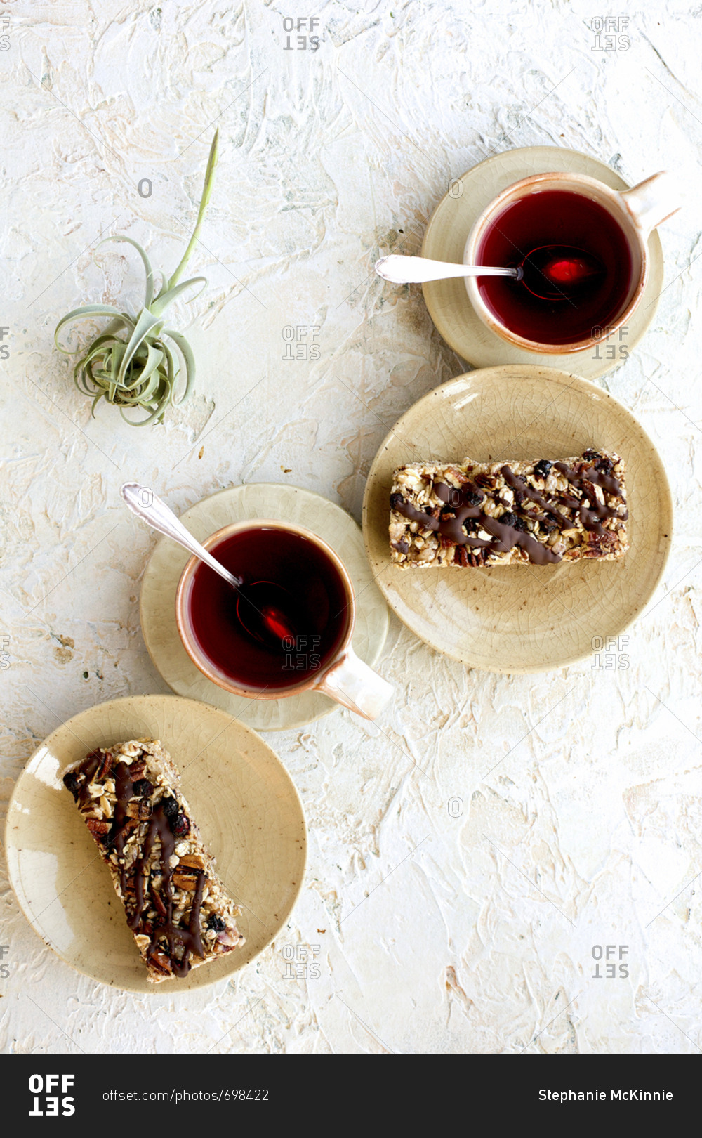 Blueberry caramelized pecan breakfast bars drizzled with dark chocolate served with hot tea