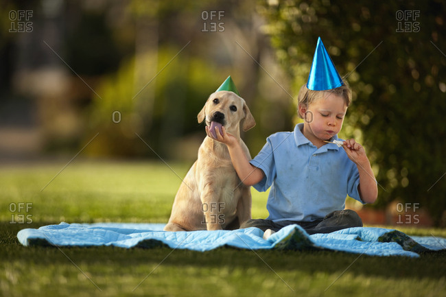 Boy having a picnic with his puppy