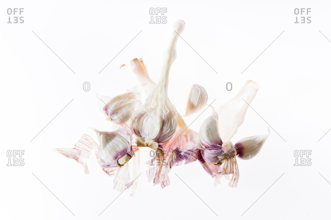 Minimalistic composition with fresh garlic on white background