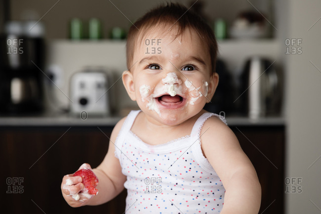 Man playing child's game with whipped cream on face Stock Photo