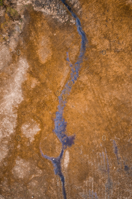 Abstract aerial view of narrow canal in wetland area in Estonia