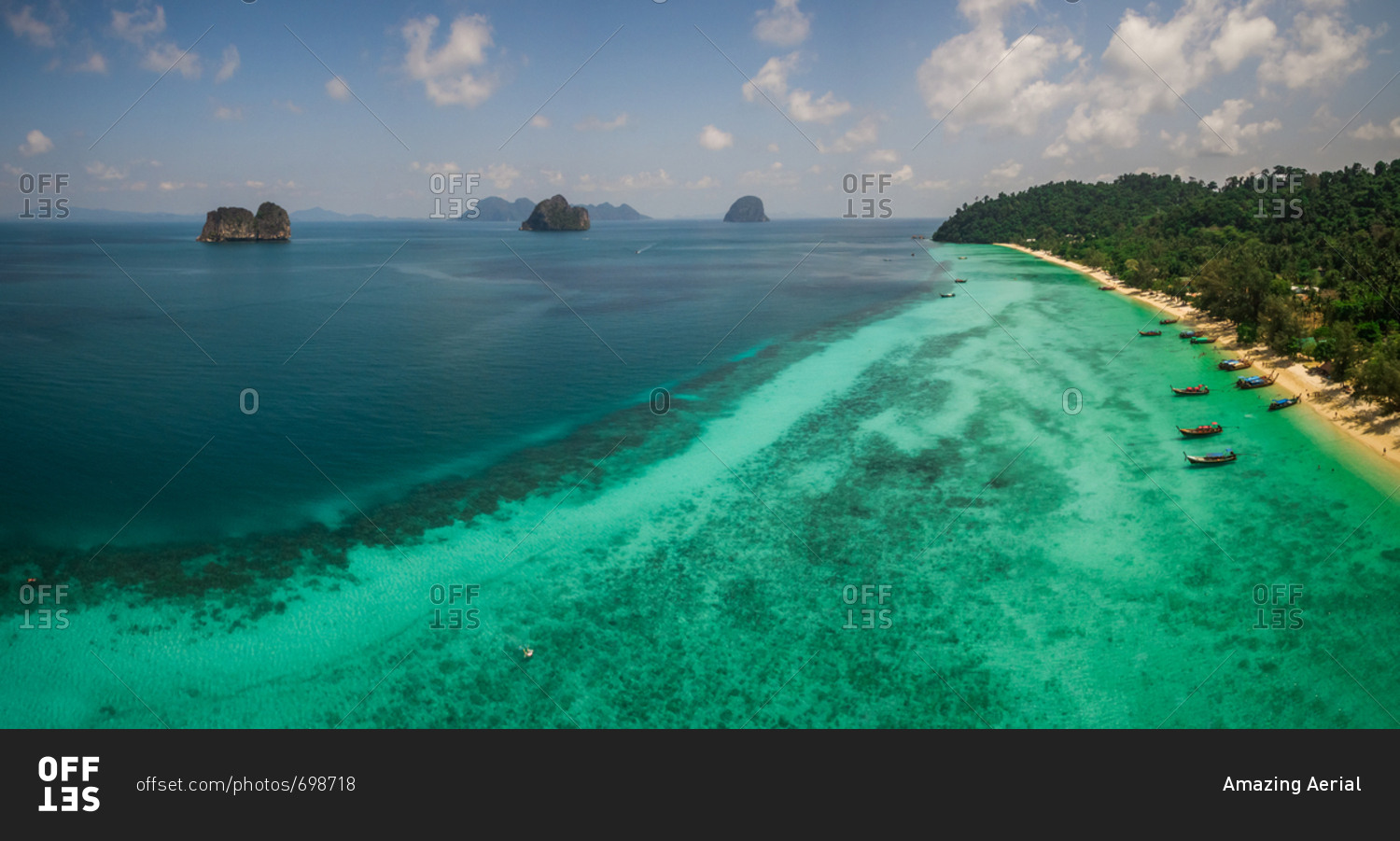 Panoramic aerial view of traditional long-tail boats moored in the bay of Chao Mai National Park in Thailand.