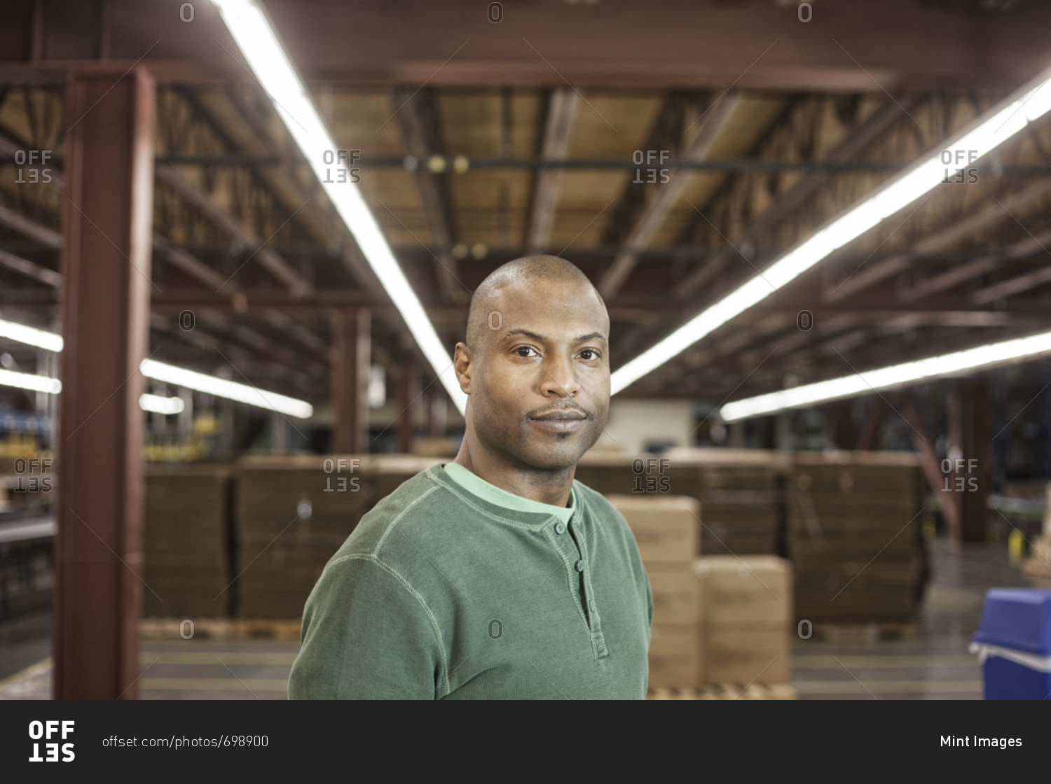 Working portrait of an African American warehouse worker in a large distribution warehouse