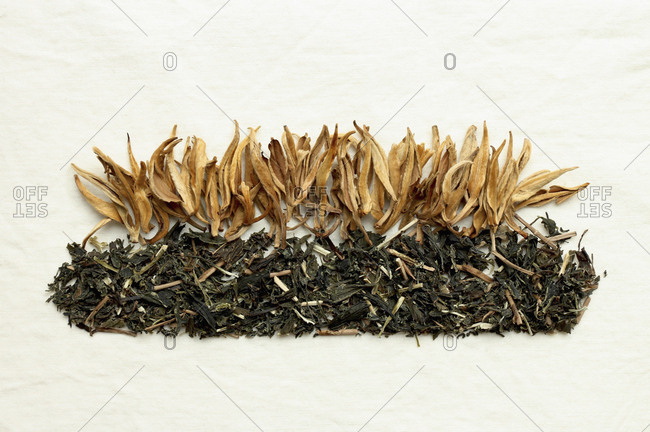 High angle view of dried tea leaves and flowers on white background