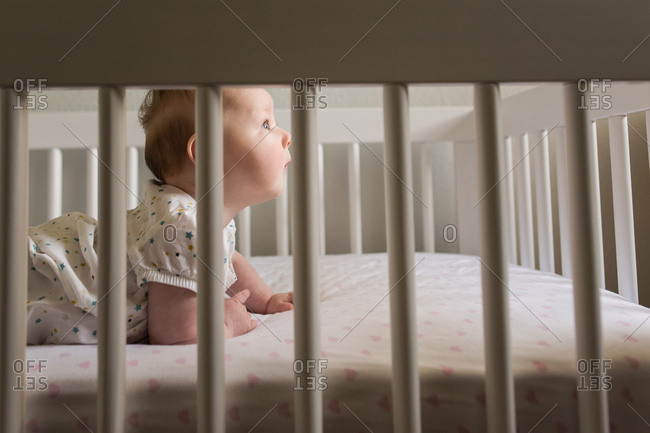 Baby in crib looking away