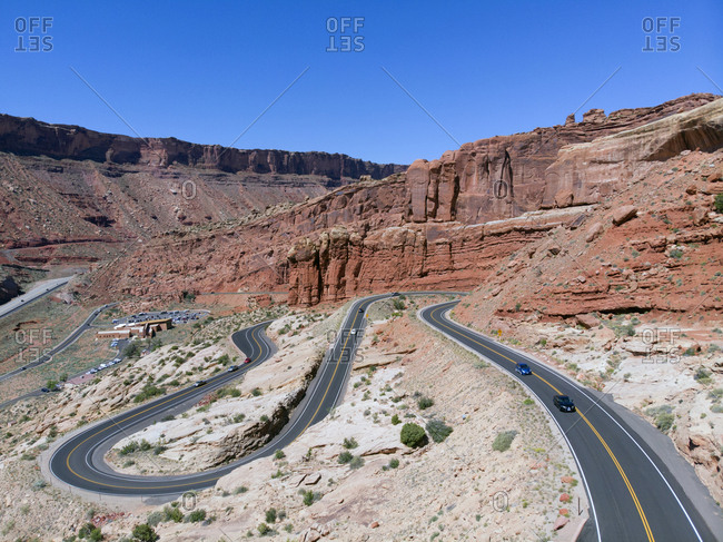 High angle view of cars driving along switchback roads winding around rock formations in Arches National Park, Utah
