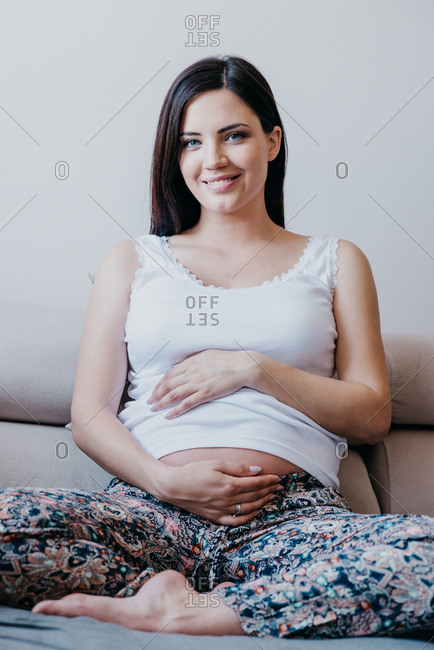 Portrait of a beautiful pregnant woman wearing a saree stock photo - OFFSET