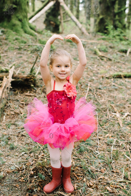Young girl in a pink ballet outfit in the woods