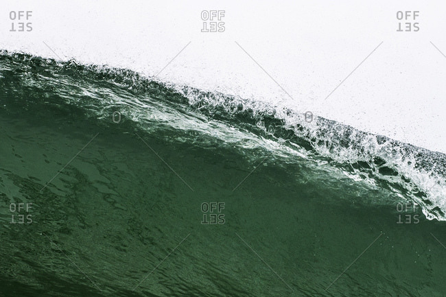 Looking up at lip of breaking wave from water level