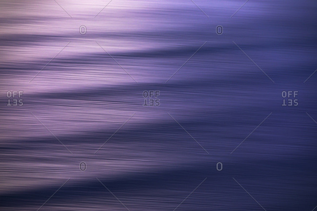 Abstract image of ripples on surface of sea at dusk
