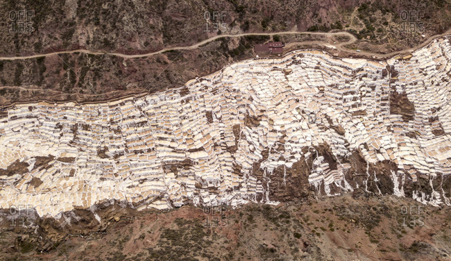 Aerial view of salt pans built on mountainside of Sacred Valley of the Incas, Maras, Cusco region, Peru