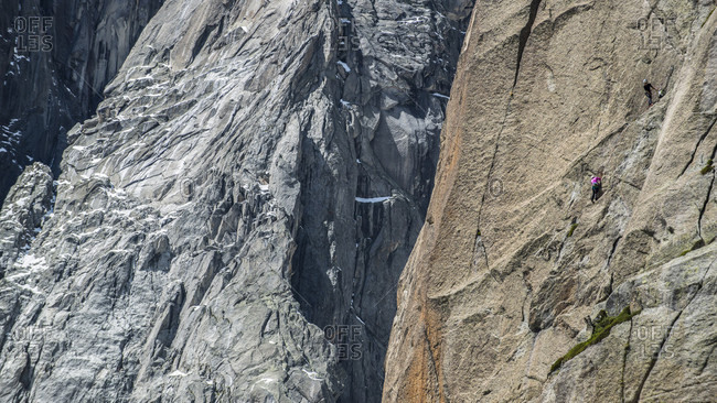 Two rock climbers challenging mountain in French Alps, Envers des Aiguilles, Haute-Savoie, France