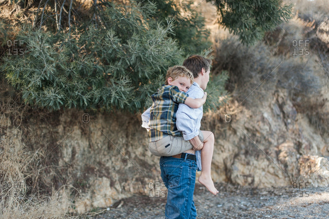 Boy giving little brother a piggy-back ride