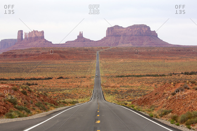 View of two lane highway through Monument Valley