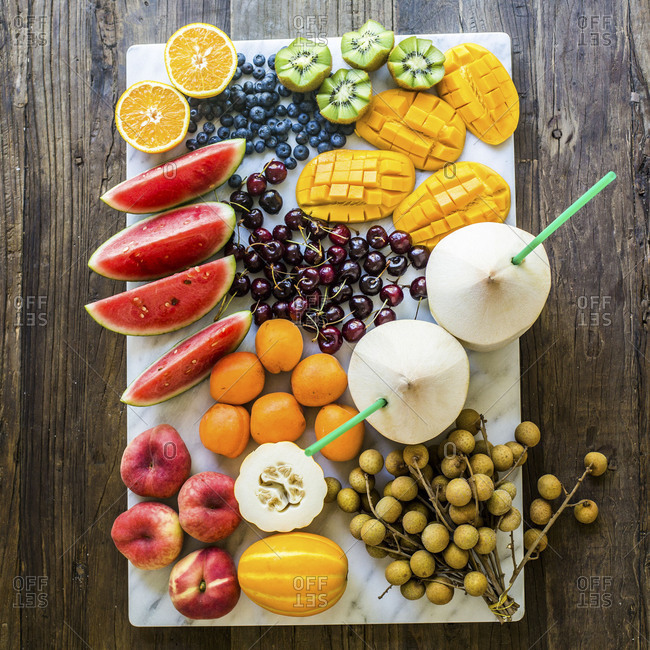 Color coordinated arrangement of miscellaneous fruits on sheet