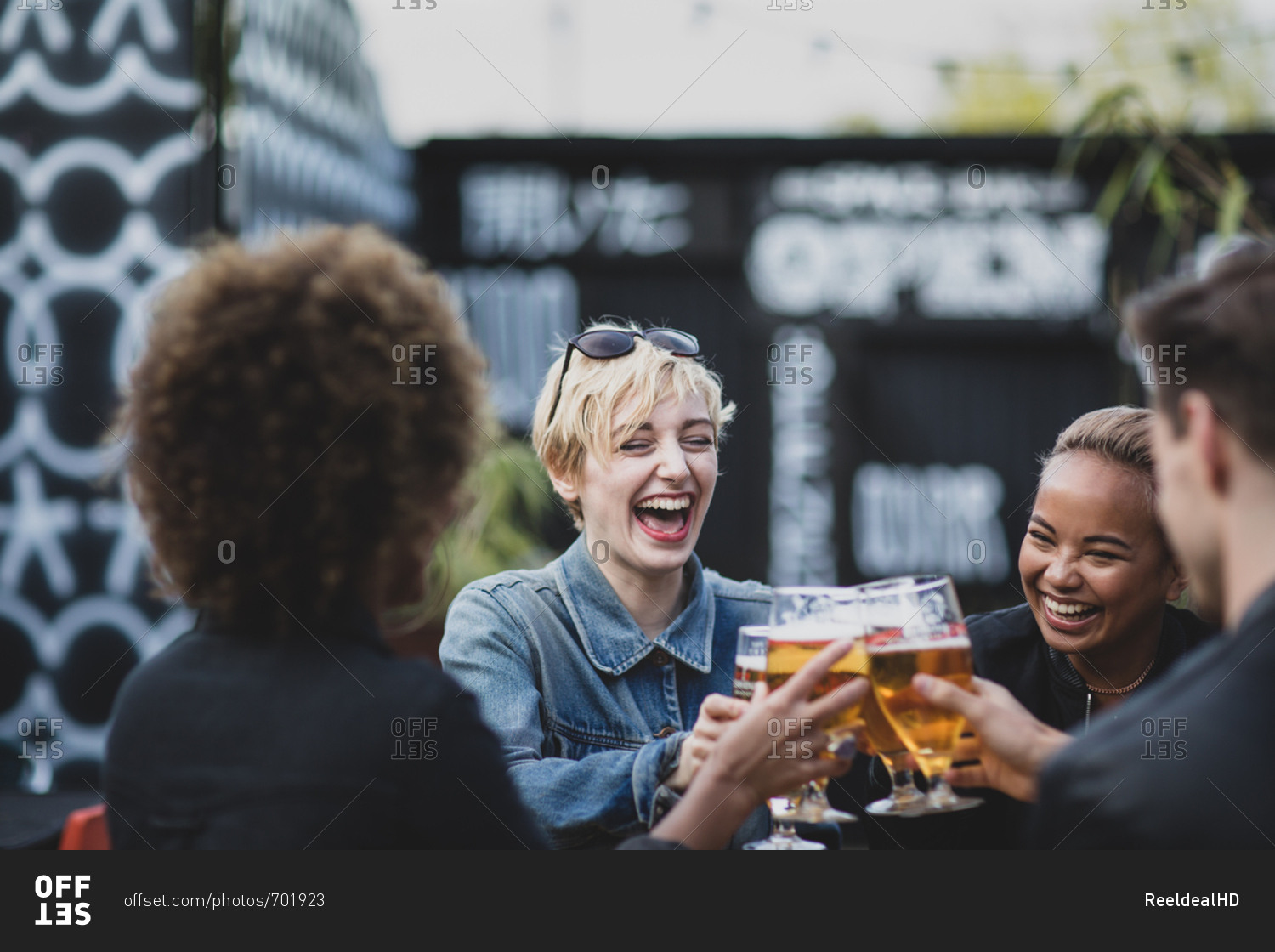 Friends drinking in an outdoor bar in summer