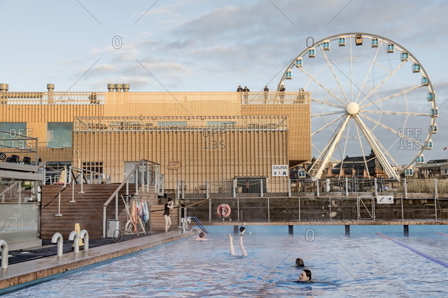 Helsinki, Finland - November 25, 2017: Swimming pool and view of Ferris wheel at Allas Sea Pool