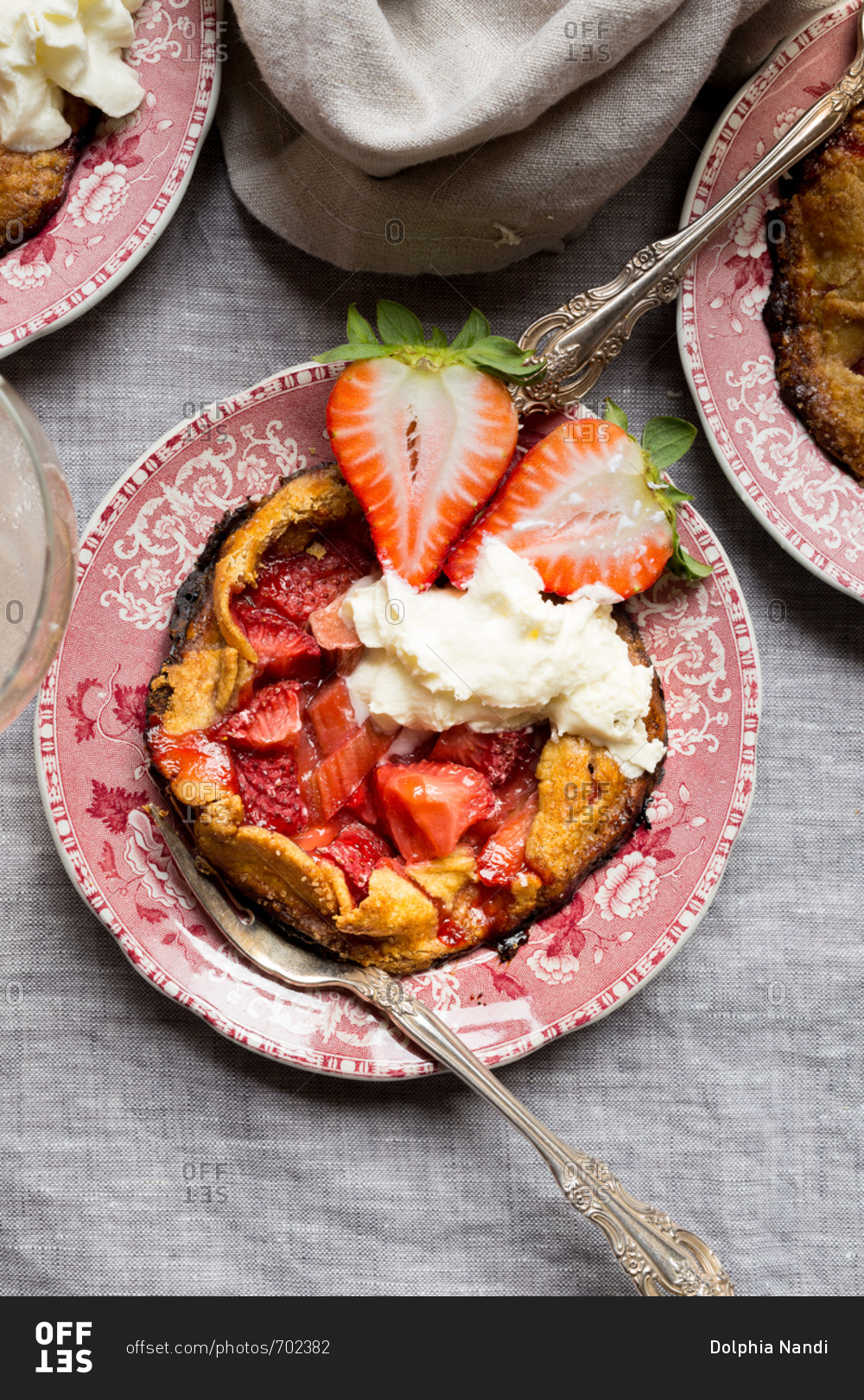 Gluten-free strawberry rhubarb pie on vintage china with rosette wine