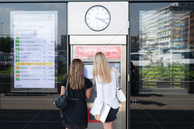 Woman purchasing tickets at station