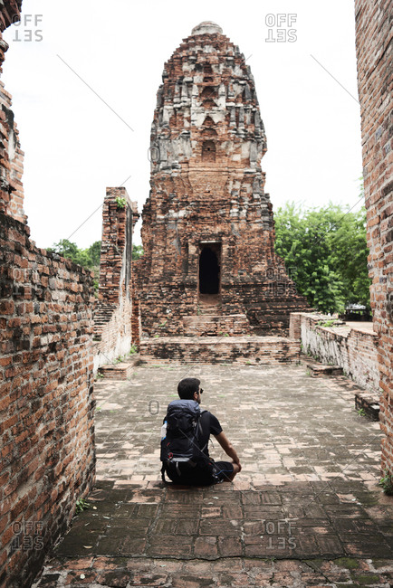 Backpacker enjoying ancient ruins in Ayutthaya, Thailand