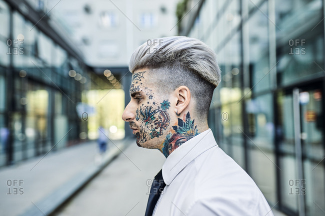 Young businessman with tattooed face walking in the city portrait Stock  Photo  Alamy