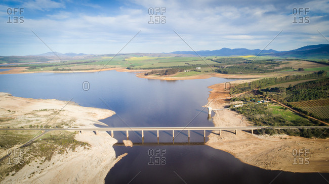 Theewaterskloof dam during the worst drought in decades in the Western Cape of South Africa with massive patches of barren earth exposed