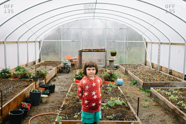 Portrait of young girl in greenhouse vegetable garden