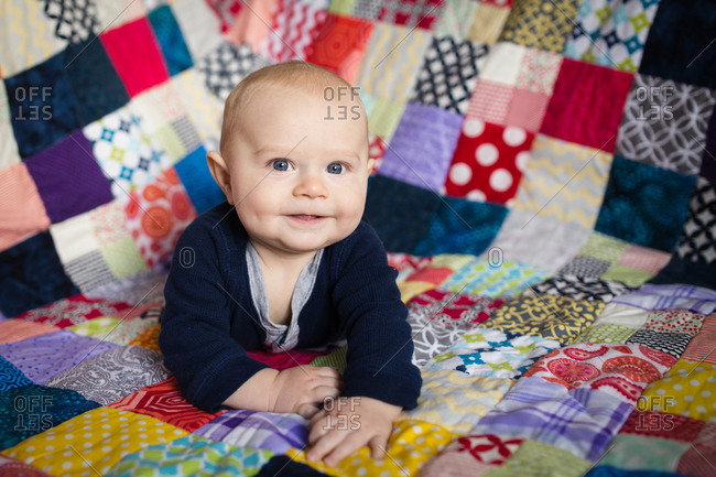 Baby on a colorful quilt