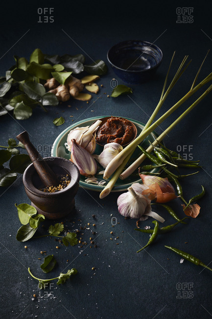 Curry paste ingredients on dark textured counter