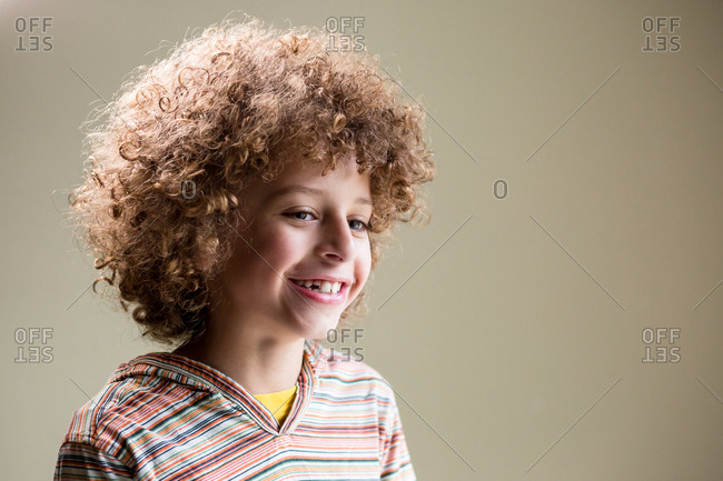 Portrait Of Young Biracial Boy In Studio Laughing And Having Fun