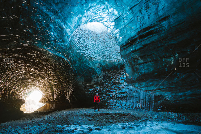 Person Staring Up At Majestic Ice Cave Ceiling Stock Photo