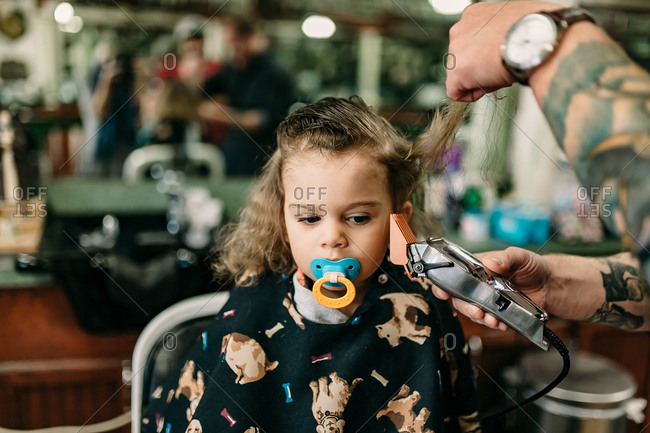 Little Boy S First Haircut At The Barbershop Stock Photo Offset