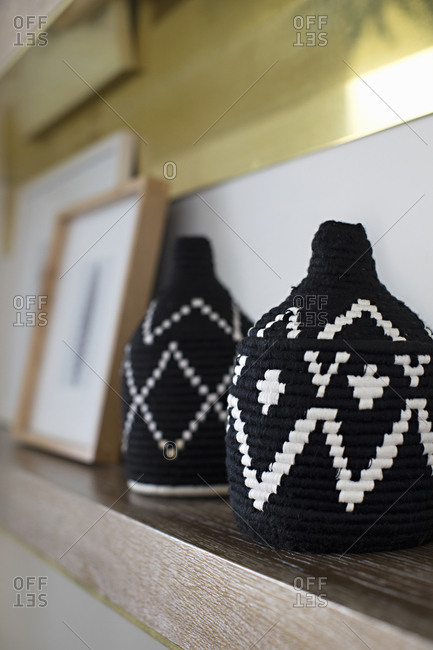 Woven baskets with traditional design displayed on mantelpiece